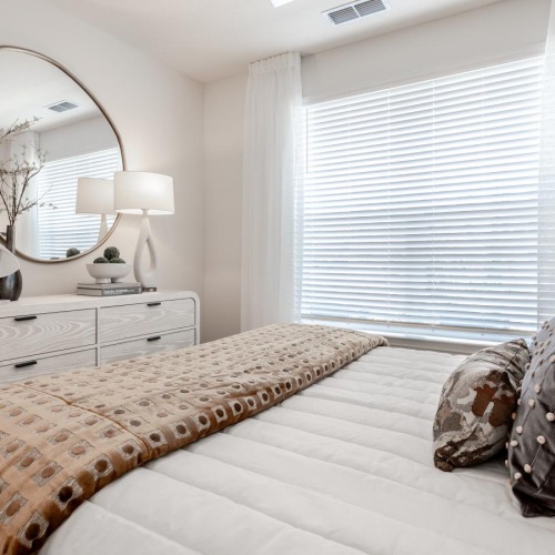 a bed with a mirror on the wall