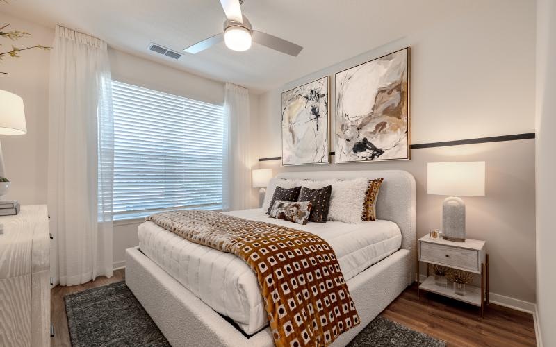 a bedroom with a bed and lamps