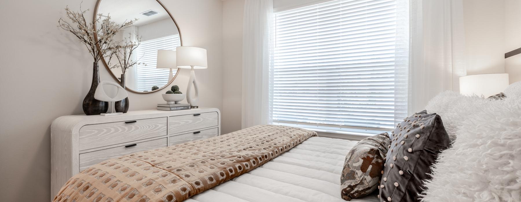 a bed with a mirror on the wall