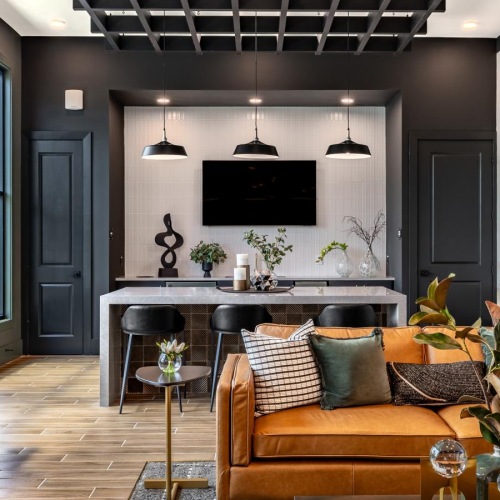 a lounge with a tv seating and tables