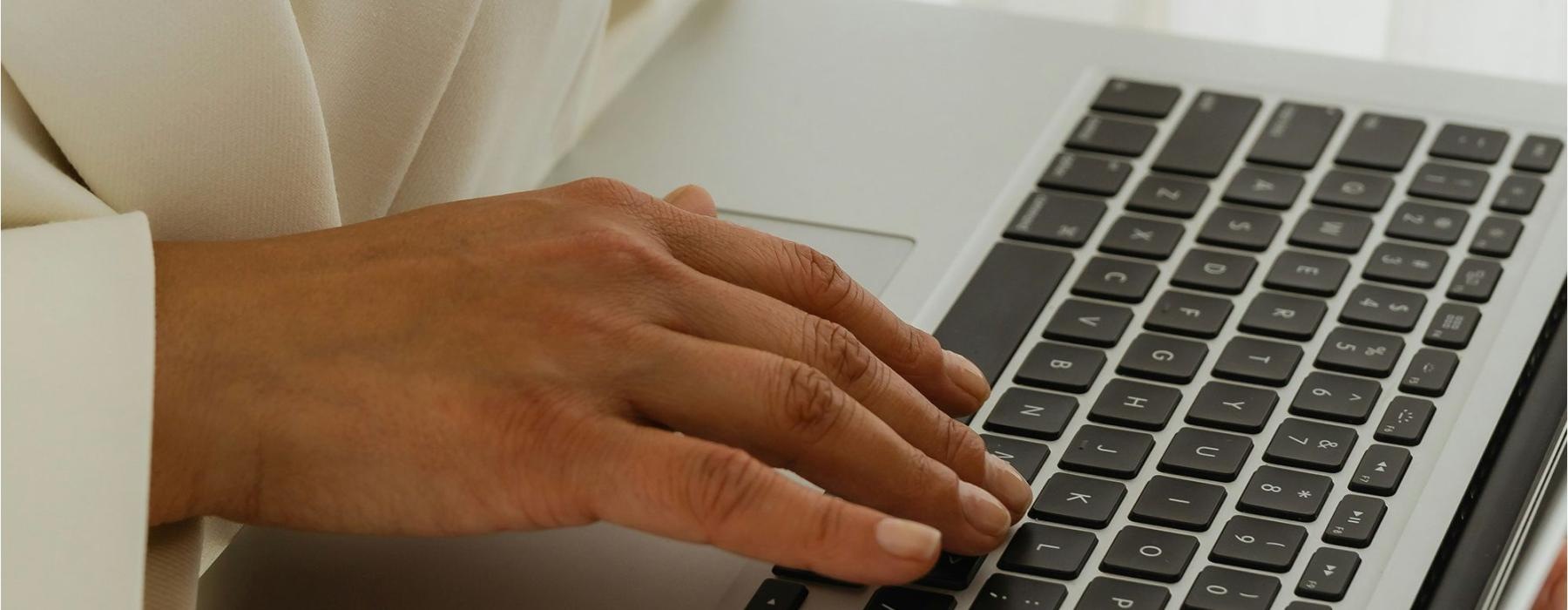 a person typing on a laptop