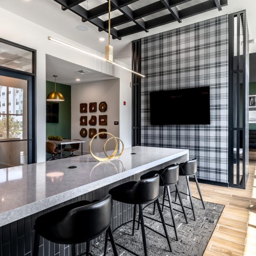 a kitchen with a tv large table and chairs